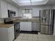 Well-lit kitchen featuring stainless steel appliances, granite countertops, and white cabinetry at 462 Cameo Dr # 462, Lakeland, FL 33803