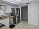 Bright kitchen with stainless steel refrigerator, white cabinets, and view into adjoining room at 462 Cameo Dr # 462, Lakeland, FL 33803