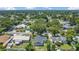 An aerial view of the home in a neighborhood with lush greenery and mature trees at 602 Taylor Blvd, Winter Haven, FL 33880