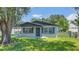 Well-maintained bungalow featuring a lush front yard and inviting entrance, perfect for first-time buyers at 602 Taylor Blvd, Winter Haven, FL 33880