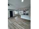 Open-concept living area featuring wood floors, modern lighting, and a view into the kitchen at 602 Taylor Blvd, Winter Haven, FL 33880