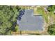 Aerial view of a well-maintained roof, surrounded by mature trees and a green lawn at 602 Taylor Blvd, Winter Haven, FL 33880