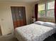 Bright bedroom with double bed, window, and closet at 619 Cassandra Ln, Lakeland, FL 33809