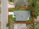 Aerial view of a house featuring a gray roof and a well-maintained backyard, with surrounding houses at 1918 Dr Martin L King Jr Way, Haines City, FL 33844