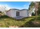 Spacious backyard with a sliding glass door leading to a patio, surrounded by a green lawn at 1918 Dr Martin L King Jr Way, Haines City, FL 33844