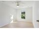 Bedroom with light wood flooring, ceiling fan, and white walls at 1918 Dr Martin L King Jr Way, Haines City, FL 33844