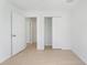 Bedroom with light wood flooring and access to closet and hallway at 1918 Dr Martin L King Jr Way, Haines City, FL 33844