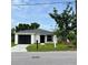 Charming single-story home with a well-manicured lawn, black garage door, and inviting curb appeal at 1918 Dr Martin L King Jr Way, Haines City, FL 33844