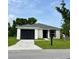Charming single-story home with a well-manicured lawn and black garage door at 1918 Dr Martin L King Jr Way, Haines City, FL 33844
