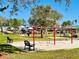 View of the park that has benches, swings, a playground, and picnic shelter at 1918 Dr Martin L King Jr Way, Haines City, FL 33844