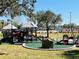 Community playground with slides, a playset, and a seating area for Gathering fun in the sun at 1918 Dr Martin L King Jr Way, Haines City, FL 33844