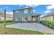 Large backyard featuring a covered patio, lush landscaping, and paved area at 6857 Eagle Ridge Loop, Lakeland, FL 33813