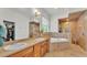 Well-lit bathroom featuring dual sinks, bathtub, walk-in shower, and walk-in closet at 6857 Eagle Ridge Loop, Lakeland, FL 33813