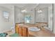 Bright bathroom featuring double vanity, plenty of cabinet space, large mirror and cute butterfly shower curtain at 6857 Eagle Ridge Loop, Lakeland, FL 33813