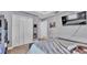 Well-lit bedroom with carpet, queen bed, white closets and television at 6857 Eagle Ridge Loop, Lakeland, FL 33813