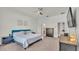 Comfortable bedroom with ceiling fan, dresser and ensuite bathroom at 6857 Eagle Ridge Loop, Lakeland, FL 33813