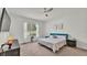 Cozy bedroom with plush carpet, ceiling fan, and windows providing backyard views at 6857 Eagle Ridge Loop, Lakeland, FL 33813