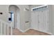 Inviting entryway with tile flooring, coat closet, and transom window above the front door at 6857 Eagle Ridge Loop, Lakeland, FL 33813