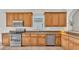 Kitchen with granite countertops, stainless steel appliances, and wood cabinets at 6857 Eagle Ridge Loop, Lakeland, FL 33813