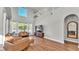 Bright living room with two-story ceiling, hardwood flooring, and large windows overlooking the yard at 6857 Eagle Ridge Loop, Lakeland, FL 33813