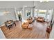 Spacious living room with hardwood floors, leather furniture, and natural light at 6857 Eagle Ridge Loop, Lakeland, FL 33813