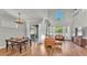 Hardwood floors highlight the spacious living room offering a view of the dining area and outdoor space at 6857 Eagle Ridge Loop, Lakeland, FL 33813