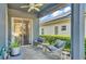 Relaxing covered patio featuring pavers, gray rocking chairs, and verdant landscaping at 6857 Eagle Ridge Loop, Lakeland, FL 33813