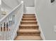 Carpeted staircase with white railing leading to the upper level at 6857 Eagle Ridge Loop, Lakeland, FL 33813