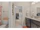 Ensuite bathroom with double vanity, mirror and framed view into other rooms at 1001 Lena Run Ct, Winter Haven, FL 33880