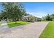 Spacious home featuring a paver driveway and lush landscaping at 1001 Lena Run Ct, Winter Haven, FL 33880