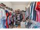Well-organized walk-in closet with ample storage shelves and hanging rods for clothes, shoes, and accessories at 1001 Lena Run Ct, Winter Haven, FL 33880