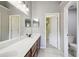 Bathroom featuring a double sink vanity, an open door and tile flooring at 1045 View Pointe Way, Lakeland, FL 33813