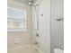 Bright bathroom featuring a shower with white tiling and chrome fixtures at 1045 View Pointe Way, Lakeland, FL 33813