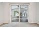Bright bedroom with large sliding doors showcasing a screened lanai area; light colored carpet flooring at 1045 View Pointe Way, Lakeland, FL 33813