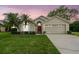 Charming single-Gathering home with a well-manicured lawn, palm trees, and a welcoming red front door at 1045 View Pointe Way, Lakeland, FL 33813