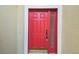 A close-up of the vibrant red front door with sidelight and golden brick, creating a welcoming entry at 1045 View Pointe Way, Lakeland, FL 33813