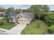 Single-story home featuring a well manicured lawn and mature landscaping at 1045 View Pointe Way, Lakeland, FL 33813