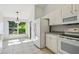 Bright, all-white kitchen featuring sleek appliances and lots of natural light coming in from the breakfast nook at 1045 View Pointe Way, Lakeland, FL 33813