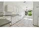 Clean white kitchen with ample cabinet space, white appliances, and natural light from the breakfast nook window at 1045 View Pointe Way, Lakeland, FL 33813