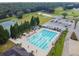 Resort-style living with an aerial view of the pool, tennis courts and lush landscaping at 1045 View Pointe Way, Lakeland, FL 33813