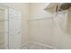 Walk-in closet featuring wire shelving, neutral walls, carpeted floor, and an entrance door at 1045 View Pointe Way, Lakeland, FL 33813