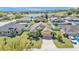 Aerial view of home showcasing landscaping, driveway, and nearby pond at 834 Auburn Preserve Blvd, Auburndale, FL 33823