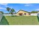 A spacious, fenced backyard featuring a well-maintained lawn and a covered patio at 834 Auburn Preserve Blvd, Auburndale, FL 33823