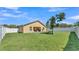 View of fenced backyard with green grass and covered patio at 834 Auburn Preserve Blvd, Auburndale, FL 33823