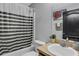 This bathroom has a shower/tub combo with a shower curtain and a single sink at 834 Auburn Preserve Blvd, Auburndale, FL 33823