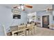 Dining area featuring a tv, ceiling fan, tile floors and open access to the living room at 834 Auburn Preserve Blvd, Auburndale, FL 33823