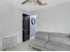 This is an empty living room with a couch and an adjacent door at 834 Auburn Preserve Blvd, Auburndale, FL 33823