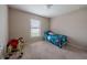 Cozy bedroom with a window and neutral carpet; playful decor suitable for a room at 1619 Prairie Blossom Dr, Lakeland, FL 33810