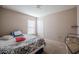 Guest bedroom featuring neutral walls and carpet, a window and simple decor; bright and inviting space at 1619 Prairie Blossom Dr, Lakeland, FL 33810