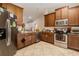 Well-lit kitchen features stainless steel appliances, tile flooring, and wooden cabinets at 1619 Prairie Blossom Dr, Lakeland, FL 33810